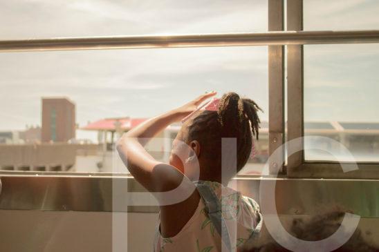 Little Girl on Boat Looking Out of Window Small