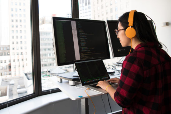 Woman-with-headphones-working-on-computer