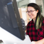 woman-smiling-on-computer