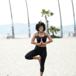 Black Woman Doing Yoga On The Beach